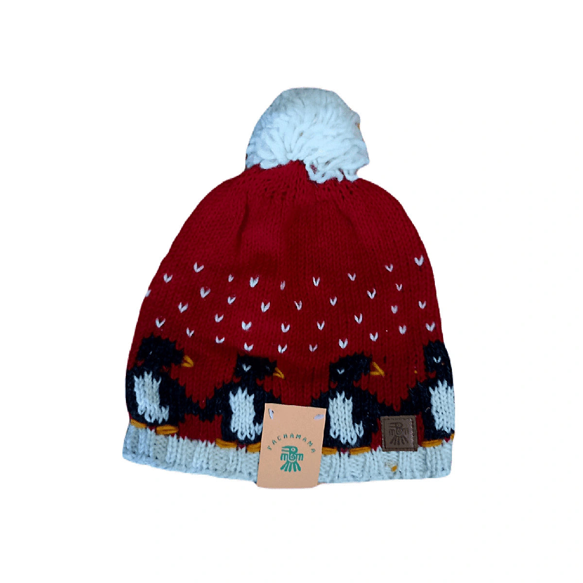 Red knit beanie with penguin design and white pom-pom on a white background