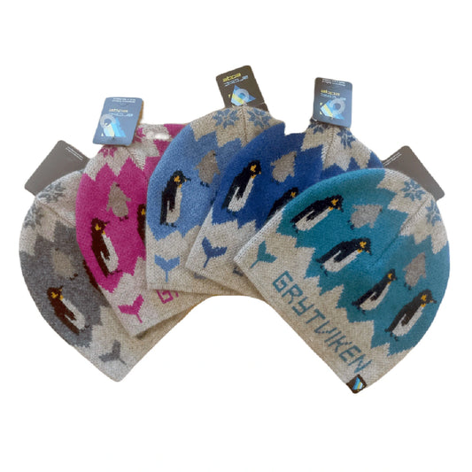 Set of four patterned hats with penguin design on a white background